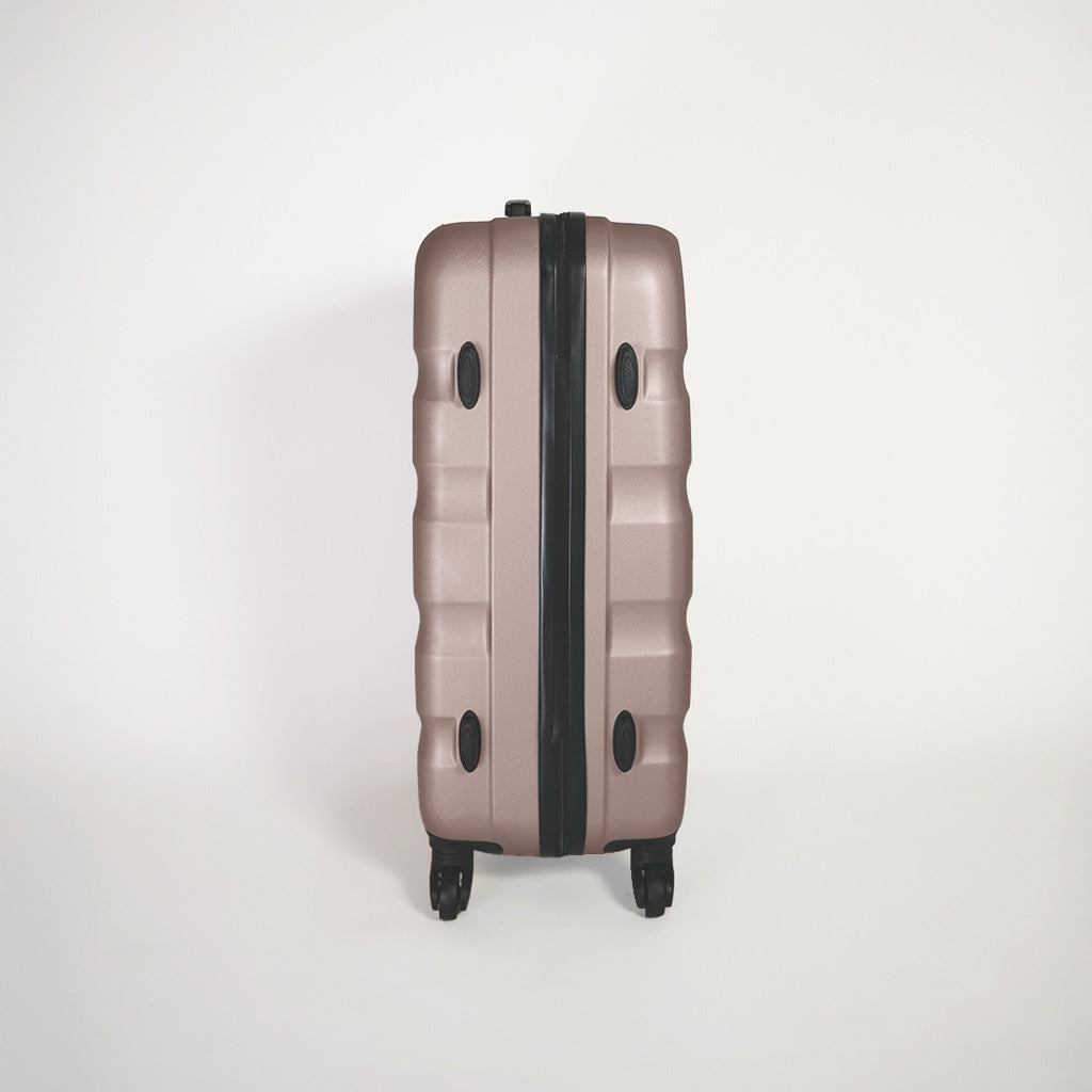 Lato destro valigia oro rosa rigida del set trolley 4 ruote con piedini